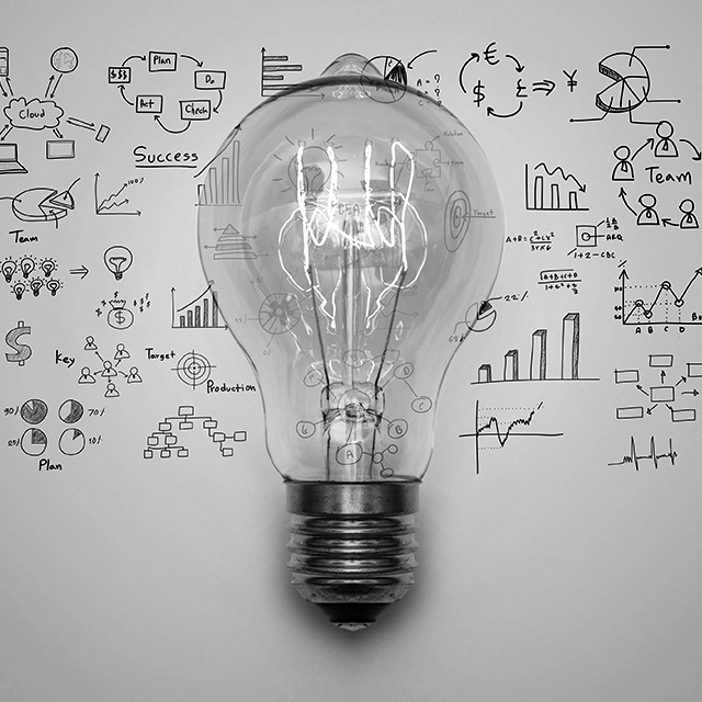 Light bulb on top of marketing drawings